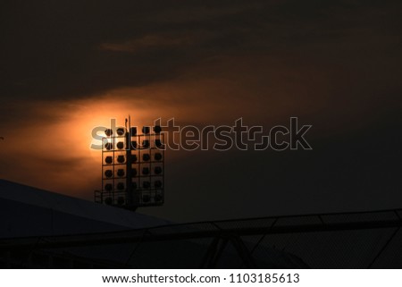 Stadium spotlight with sunset, a silhouette picture.