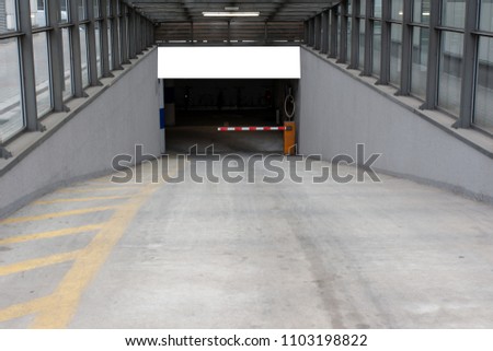 Blank White and Isolated Mockup billboard poster on the wall of entrance to the underground garage