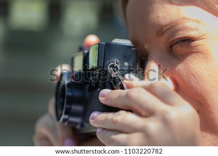 A young woman taking pictures with her camera
