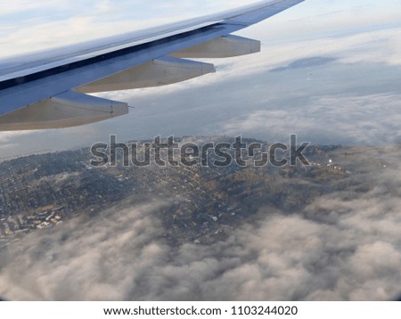 Aerial view of Seattle, Washington with an aircraft wing in the picture.