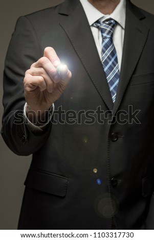 Man in suit touching virtual screen with pen tool