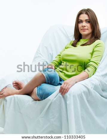 Portrait of a smiling young woman relaxing on the couch . isolated on white