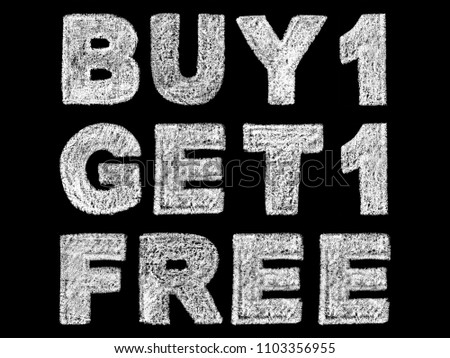 handwritten white bold chalk lettering buy 1 get 1 free text on black background, hand-drawn chalk phrase, back to school concept, stock photo image