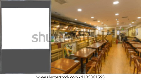 The advertisement lamp box and the vague restaurant interior vie
