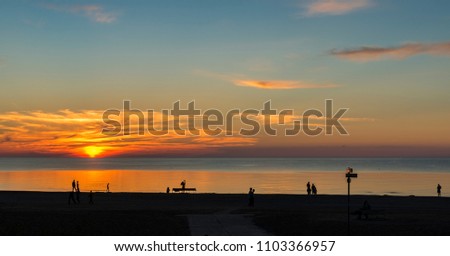 Sunset at sandy beach of the Baltic Sea, time of summer vacation. Jurmala, Latvia
