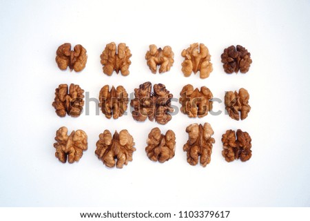 peeled halves of walnut on white background