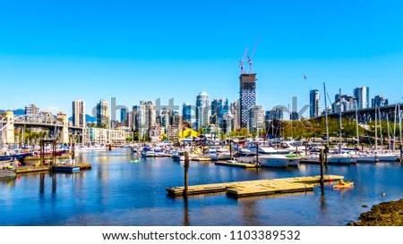 Skyline of the City of Vancouver, British Columbia, Canada with lots of boating activity at False Creek on a clear summer day