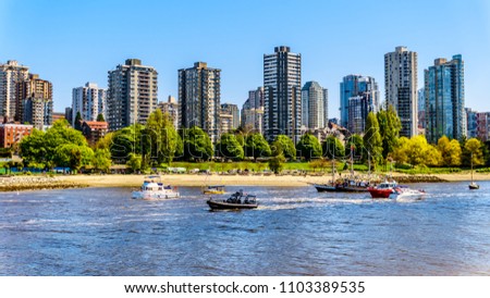 Skyline of the West End of the City of Vancouver, British Columbia, Canada with lots of boating activity at the inlet of  False Creek on a clear summer day