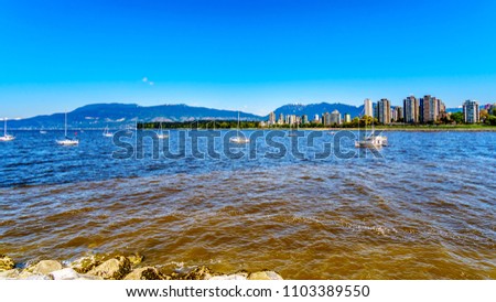 Skyline of the West End of the city of Vancouver British Columbia with the busy False Creek inlet popular with boaters in the foreground