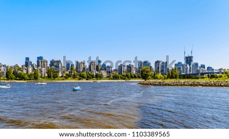 Skyline of the West End of the city of Vancouver British Columbia with the busy False Creek inlet popular with boaters in the foreground