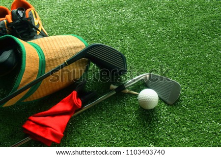 Golf balls and golf equipment are placed on fresh green lawns.