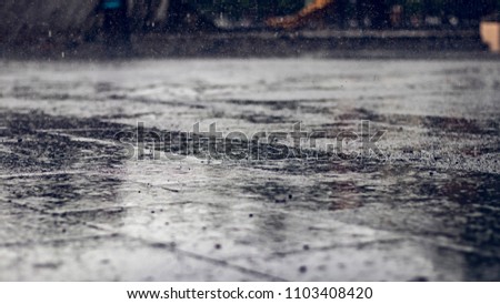 Wet rainy floor ground on a urban cityscape Royalty-Free Stock Photo #1103408420
