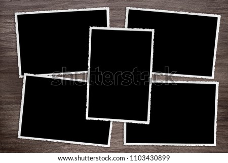 five blackened old vintage photo templates on rustic wooden background