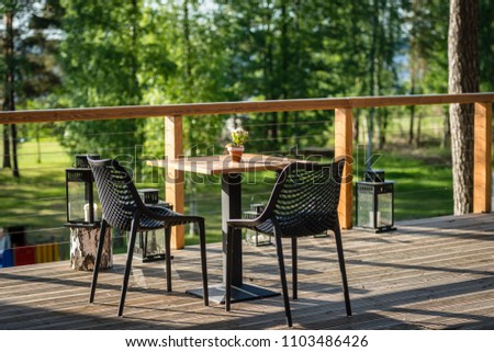 Chairs and table cafes on the outdoor terrace.