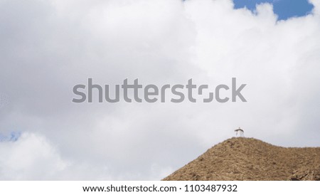 Mountain peak with some clouds and clear blue sky