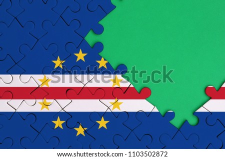 Cabo verde flag  is depicted on a completed jigsaw puzzle with free green copy space on the right side
