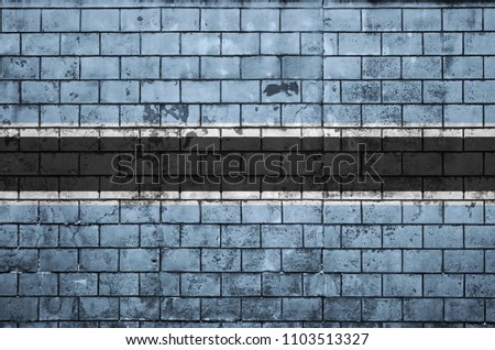 Botswana flag is painted onto an old brick wall