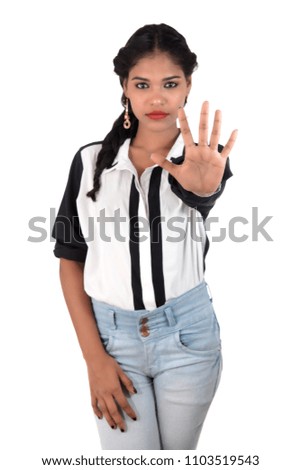 Portrait of a beautiful girl showing stop sign with palms isolated on a white background