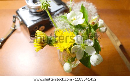 Bouquet of summer flowers on brown background. Photographer's workplace