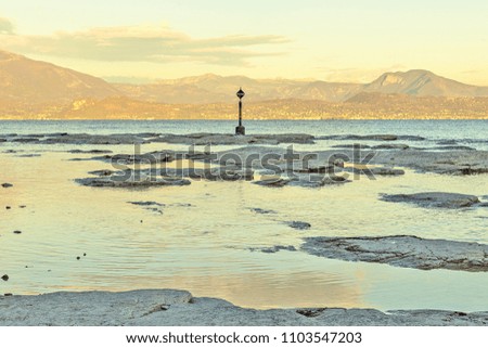 Rocky seashore view. Beautiful area of stony, or rocky land bordering and level with the sea. Nature, weather and landscape concept photo
