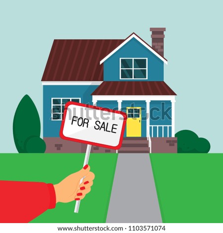 Hand holds a sign "for sale" on house background