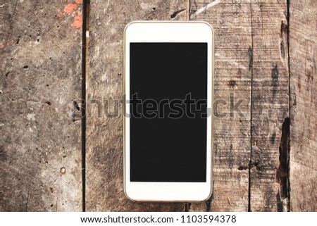 Smart phone on wood background