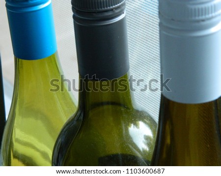 The lids of 3 wine bottles