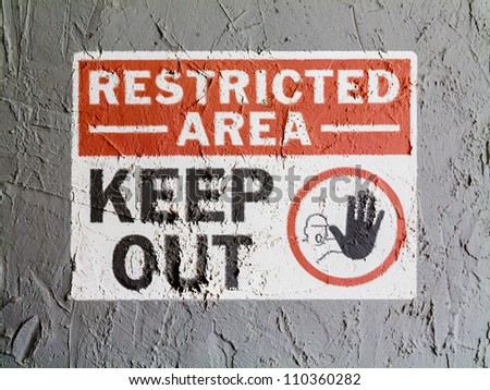 Restricted area sign painted on wall