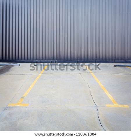 Urban grungy parking wall, may be used as background or texture