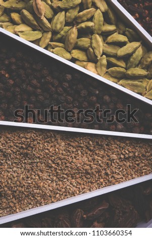 Indian colourful Spices in a white Sunburst or sun rays shape designer container, selective focus.

