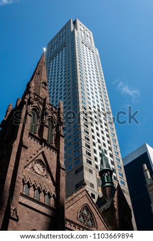 Detail of the facade of the Fifth Avenue Presbyterian Church, with a skyscraper on the background, in New York City, USA.