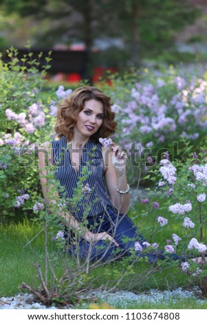 a girl with a flowering bush