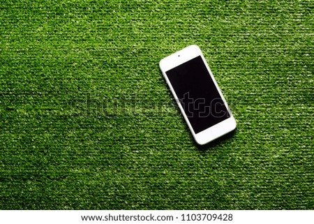 phone on the grass. football field.