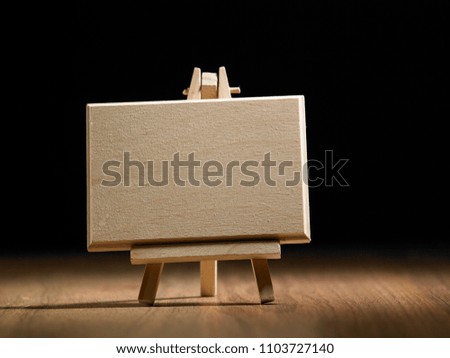 blank wooden board with easel stand