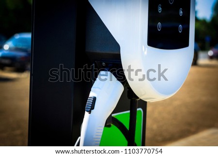 The station is white for refueling an electric car. There is a place for recording at the bottom. Royalty-Free Stock Photo #1103770754