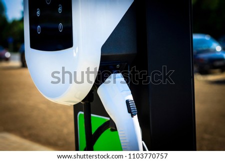 The station is white for refueling an electric car. There is a place for recording at the bottom. Royalty-Free Stock Photo #1103770757