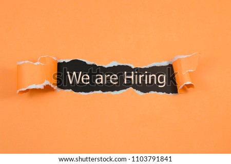 We're Hiring written under torn paper. Human resource concept, strategy, plan, planning. Royalty-Free Stock Photo #1103791841