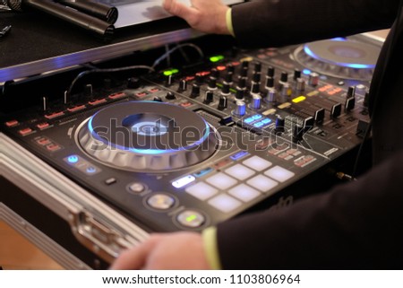 dj musical mixer professional console black color with many buttons and knobs in night club or studio, horizontal picture