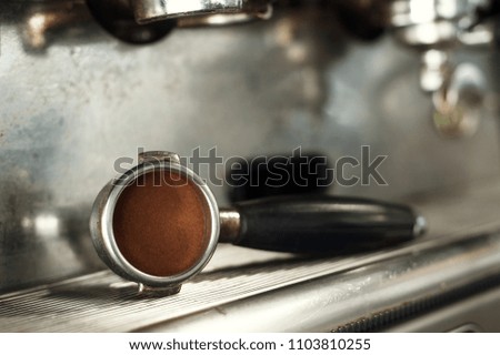 Making espresso and holding the grip right before the espresso is pressed.