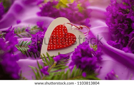 Red wooden heart on a wooden background