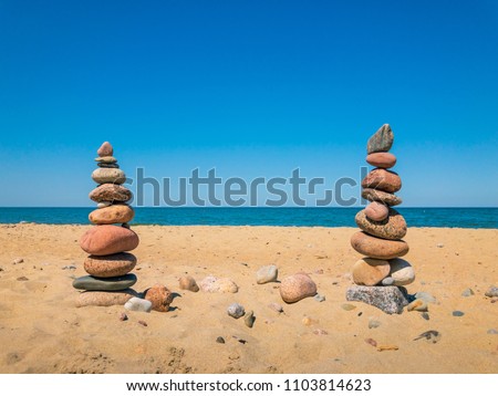 Stones in the pyramid stand on the sandy sea beach