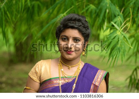 Indian Beautiful young girl in Traditional 
 Saree posing outdoors