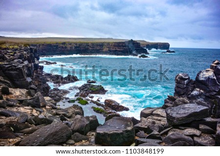 Volcanic rock along the coastline of Suarez Point, Espanola, in the Galapagos Islands Royalty-Free Stock Photo #1103848199