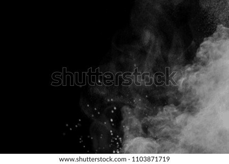 White Powder explosion on black background. White dust exploding.