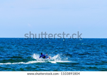 Kitesurfing on the waves of the sea in Mui Ne beach, Phan Thiet, Binh Thuan, Vietnam. Kitesurfing, Kiteboarding action photos