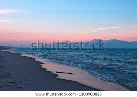 sunset on the beach. gradient sky from blue to pink. sea and mountains on sky backround