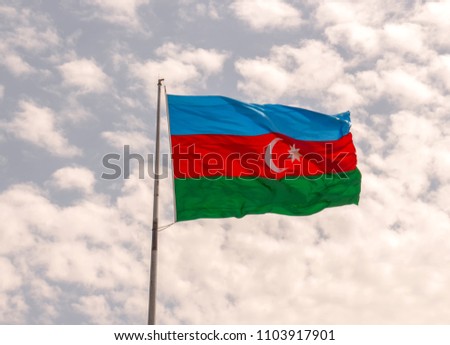 flag of the country Azerbaijan developing in the wind against the blue sky