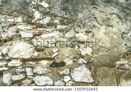 Stone wall with fragile plaster as a background.
