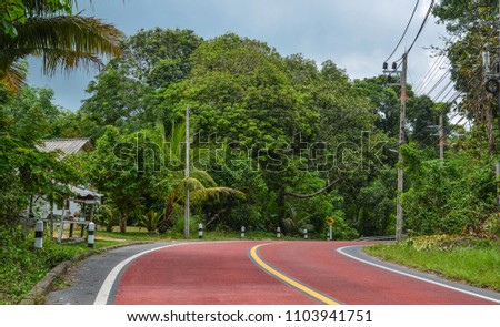 Rural road at summer day on Phuket Island, Thailand.