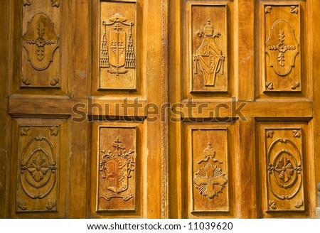 Golden Brown Wooden Church Door with Religious symbols Tlaquepaque Guadalajara Mexico Resubmit--In response to comments from reviewer have further processed image to reduce noise and sharpen focus.